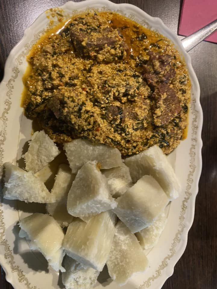 Egusi soup served with boiled yam