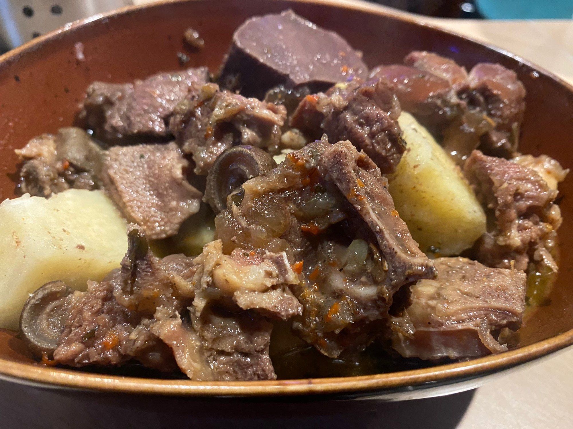 Pepper soup with meat and yam in a copper bowl