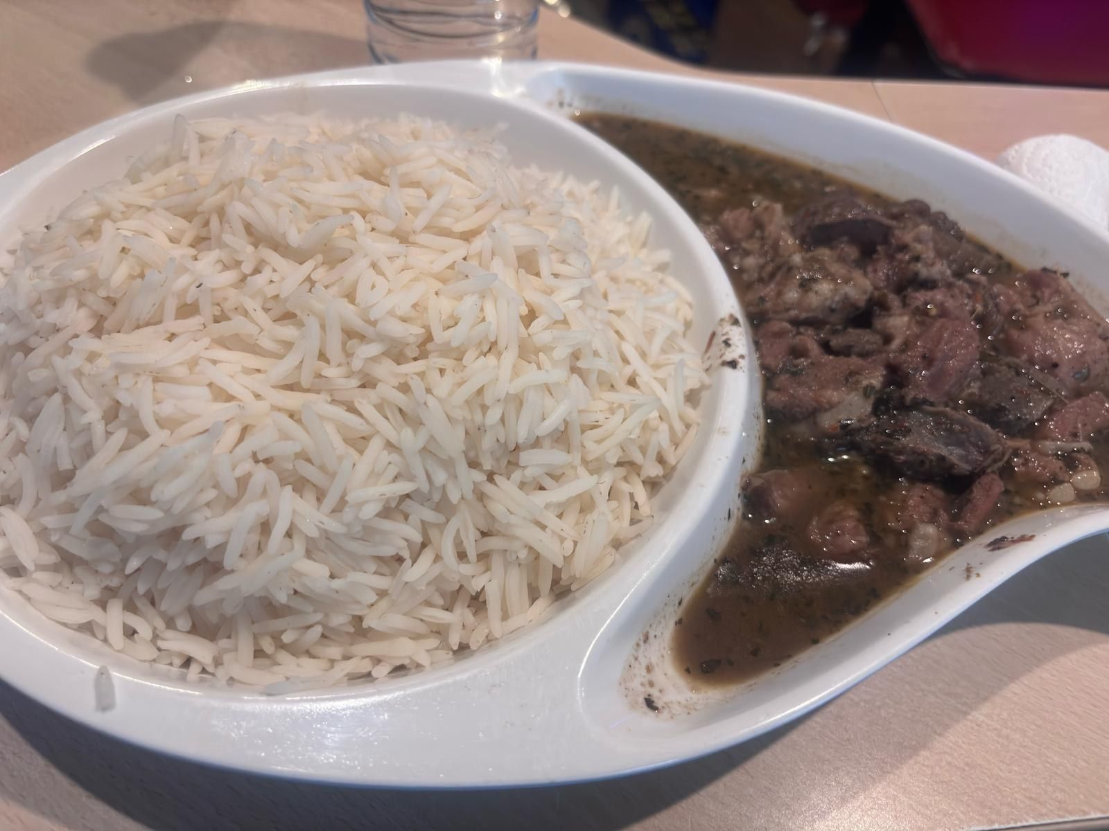 White rice in a divided dish with meat stew